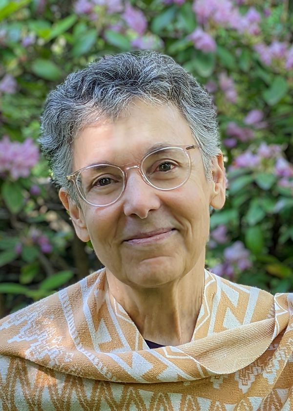 a photographic portrait of Shulamith wearing a warm smile